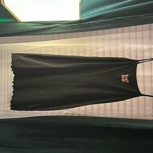 Medium , short, black dress with butterfly on front.